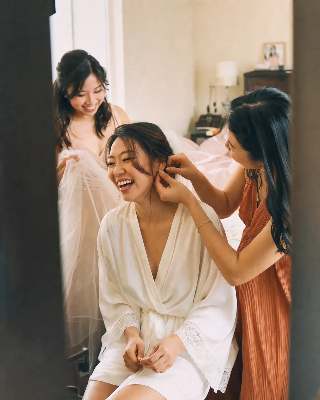 Friends sharing a candid getting-ready moment before a wedding.